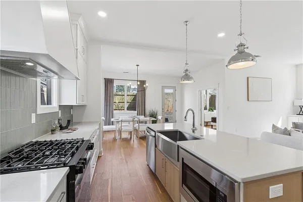 a kitchen with sink stove and cabinets