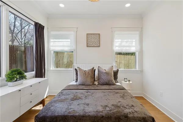 a bedroom with a large bed and a window