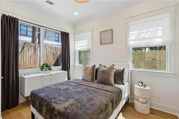 a bedroom with a bed and wooden floor