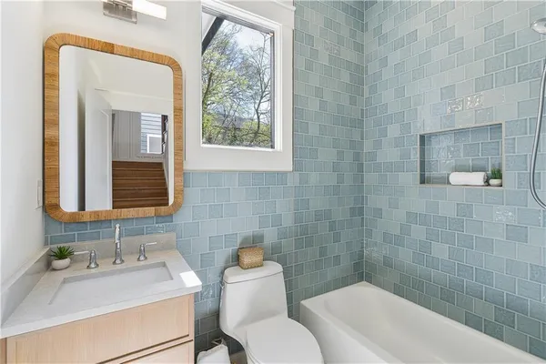 a bathroom with a sink mirror toilet and bathtub