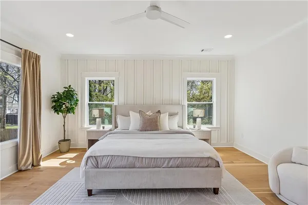 a bedroom with a large bed and a large window