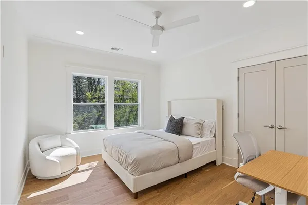 a bedroom with a bed and a chair