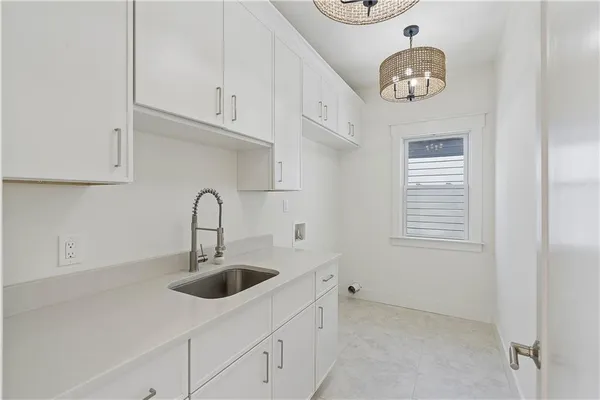 a kitchen with stainless steel appliances a sink dishwasher and cabinets