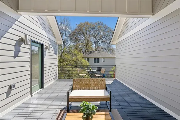 a view of a patio with table and chairs with wooden floor and fence