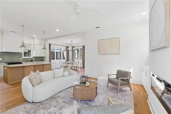a living room with furniture and a wooden floor