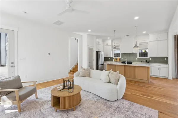 a living room with furniture and kitchen view