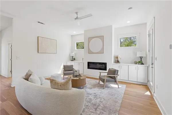 a living room with furniture a fireplace and a flat screen tv
