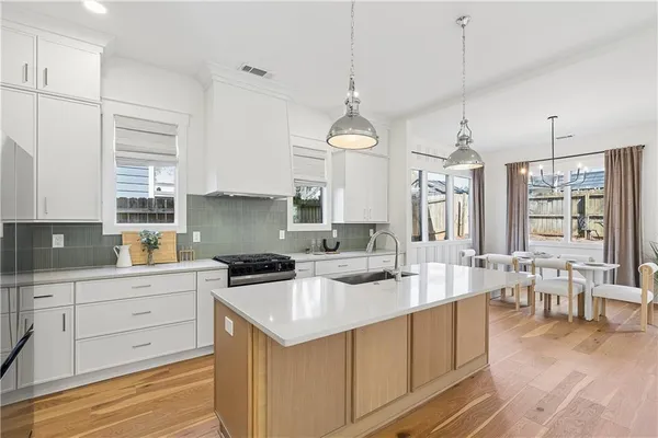 a kitchen with a sink stove and cabinets