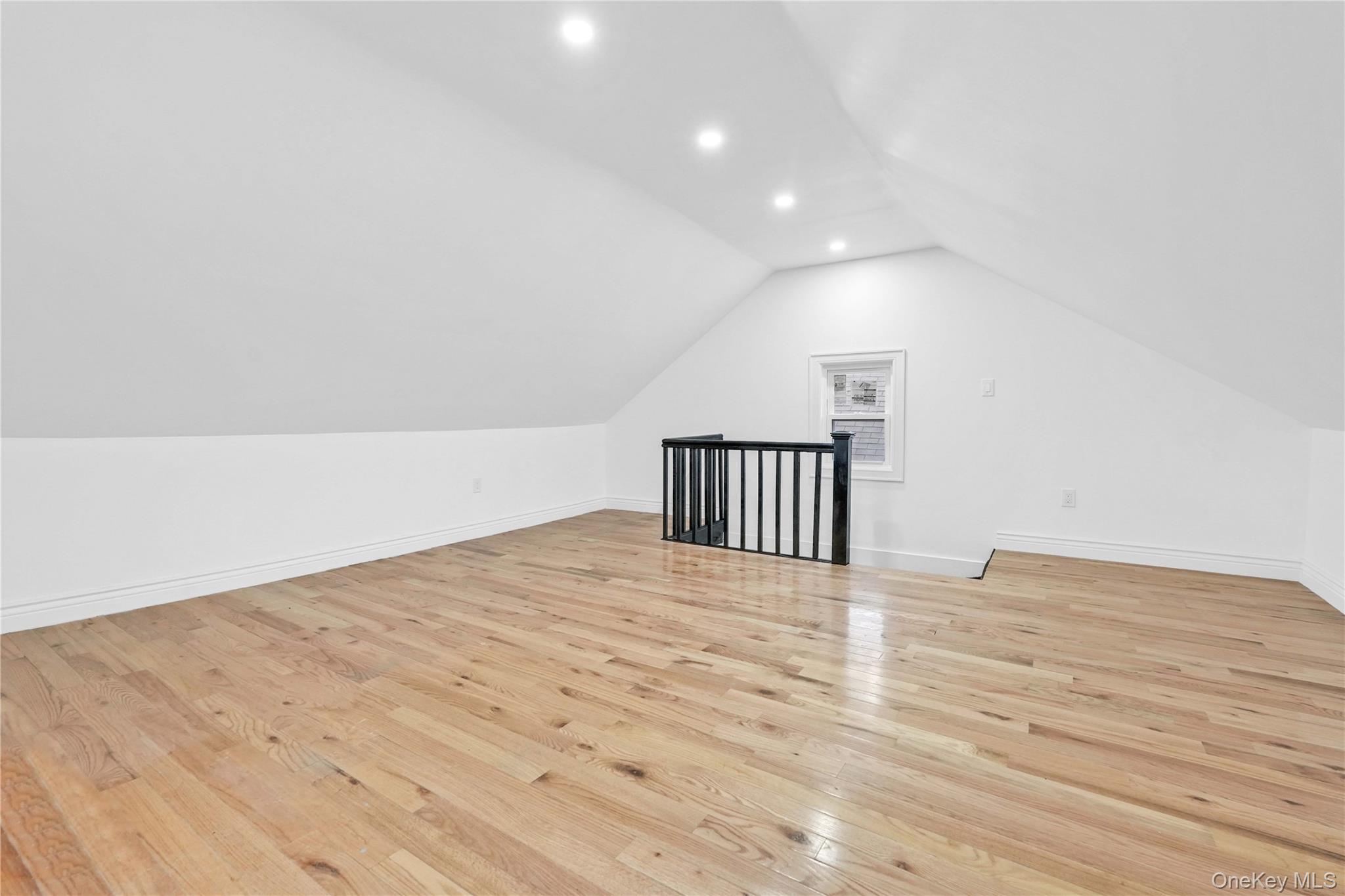 21432 112th Road Queens, NY 11429 - Photo 8 of 18 Bonus room featuring light wood finished floors, recessed lighting, and vaulted ceiling