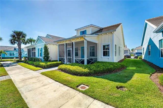 a view of a big house with a big yard and potted plants