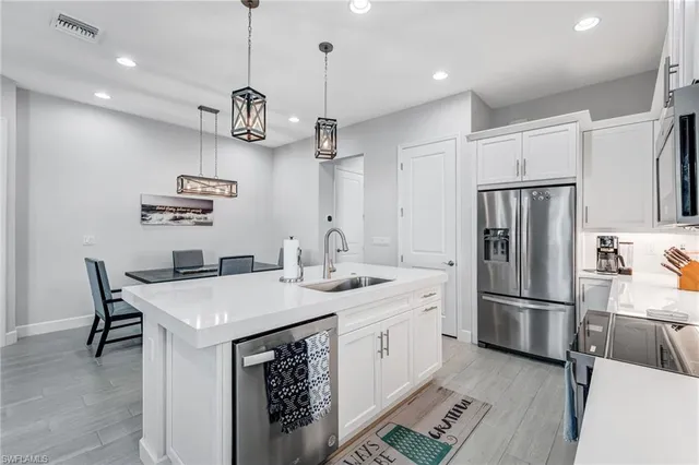 a kitchen with a refrigerator a sink and a refrigerator