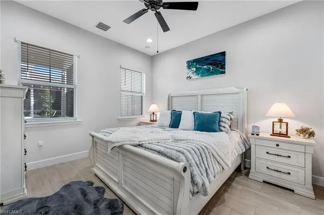 a large kitchen with cabinets a sink dishwasher a stove and a dining table with wooden floor