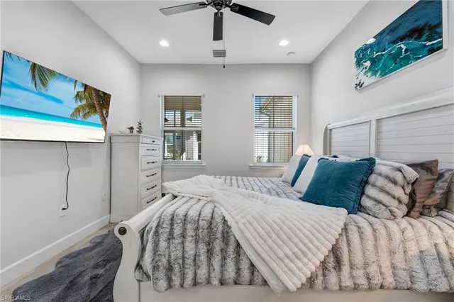 a bedroom with bed mirror and a furniture