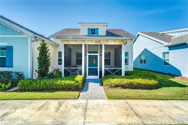 a front view of brick house with a yard
