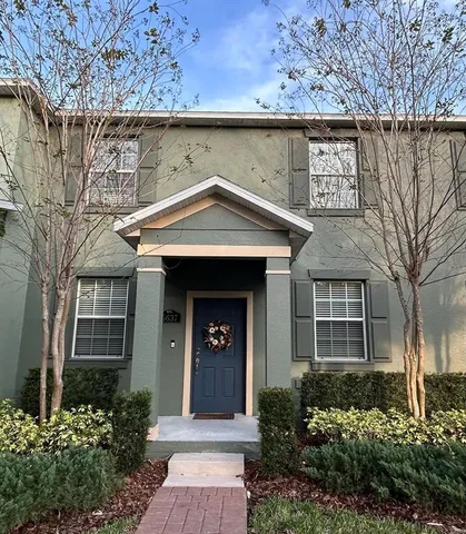 a front view of a house with a garden