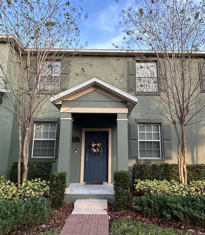 a front view of a house with a garden