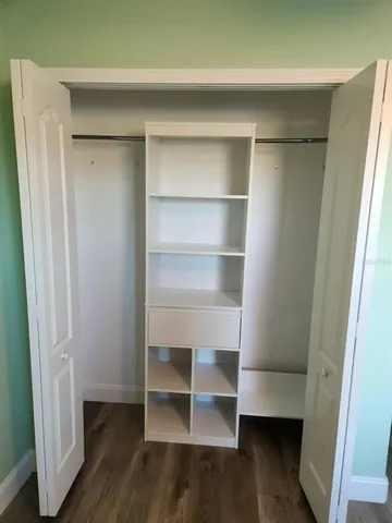a view of walk in closet with empty racks