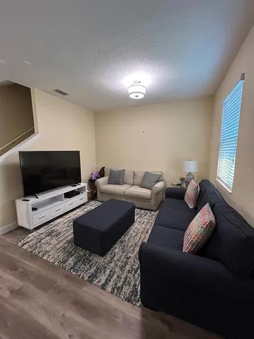 a living room with furniture and a flat screen tv
