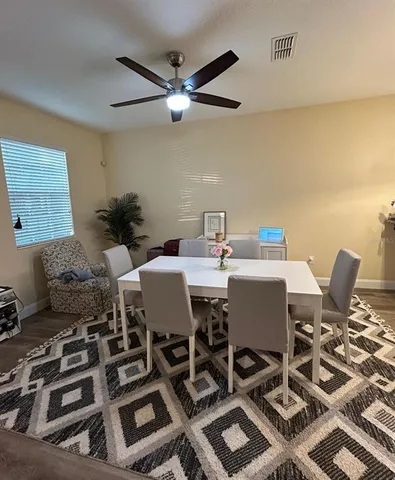 a view of a dining room with furniture and a rug