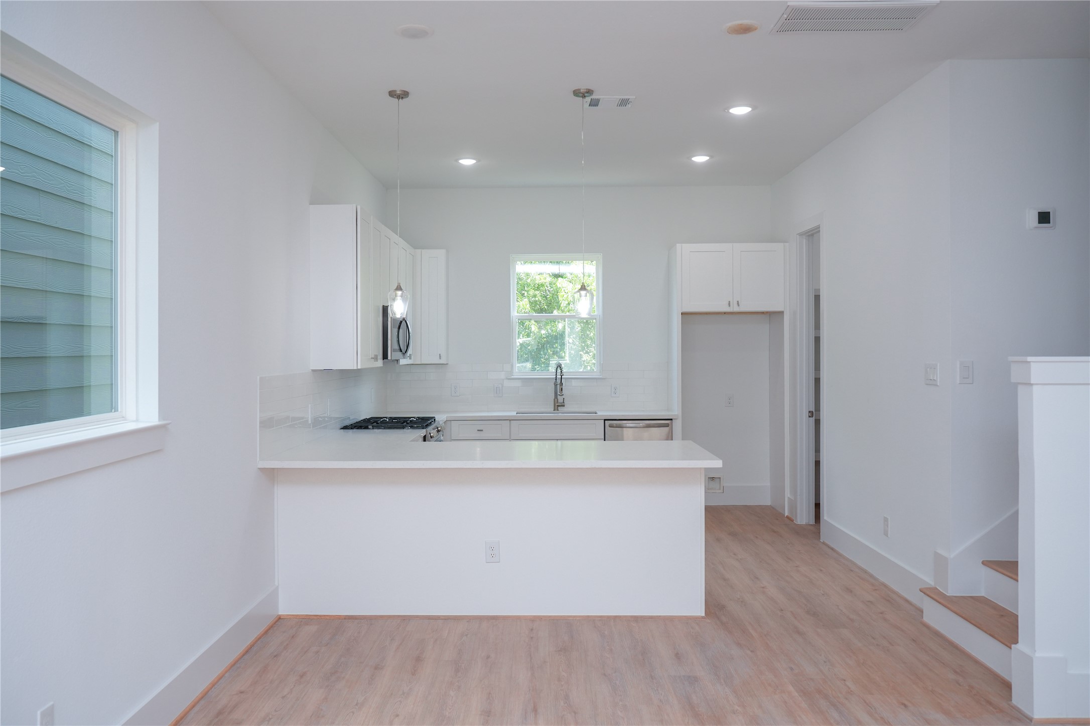 6728 Peerless Street, Unit E Houston, TX 77021 - Photo 11 of 13 a view of cabinets a sink and a refrigerator in a room