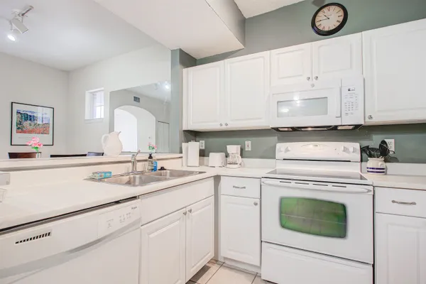 a kitchen with cabinets appliances a sink and a counter top space