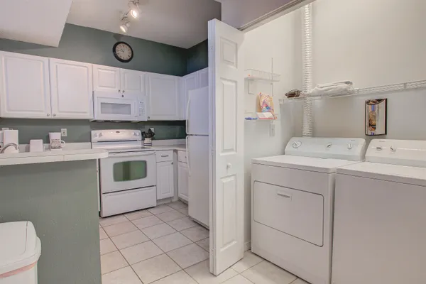 a kitchen with cabinets appliances and a sink