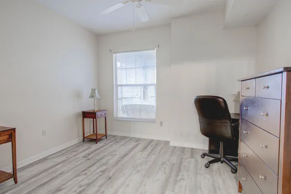 a view of a workspace with furniture and a window
