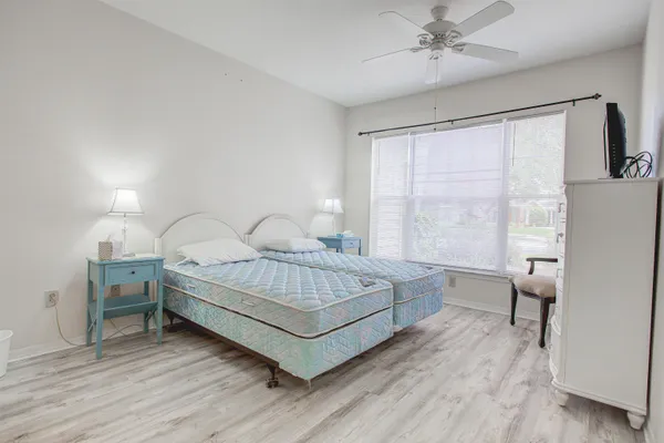 a bed room with a bed and a chair