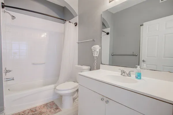 a bathroom with a sink toilet tub and shower