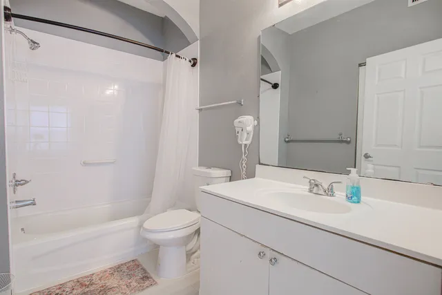 a bathroom with a sink toilet tub and shower