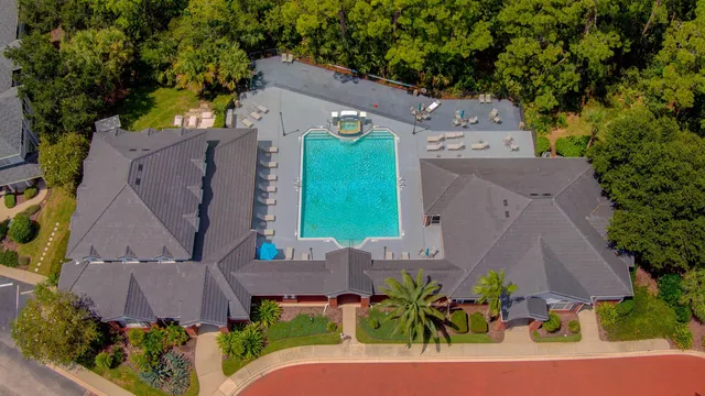 an aerial view of a house with a yard and garden