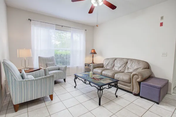 a living room with furniture and a large window