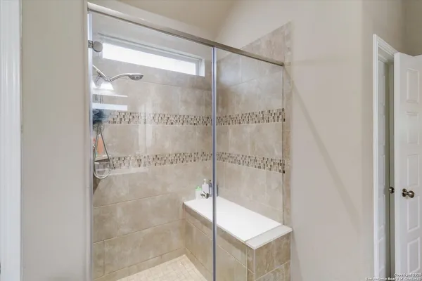 a bathroom with a glass shower door