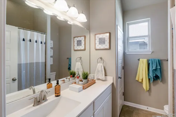 a bathroom with double vanity sink and a mirror