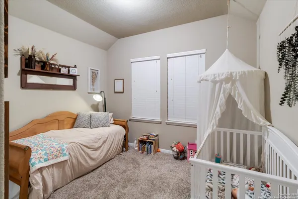 a bedroom with furniture and wooden floor