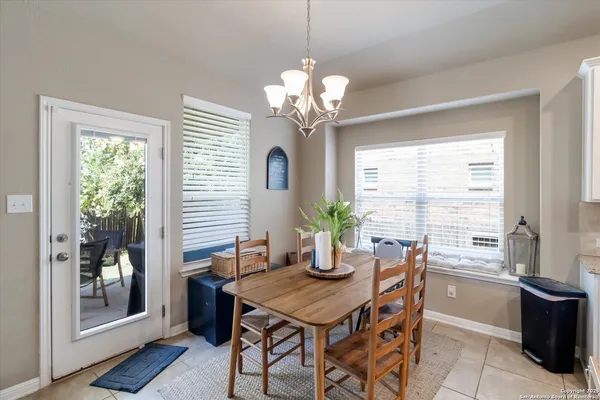 a dining room with furniture a large window and wooden floor
