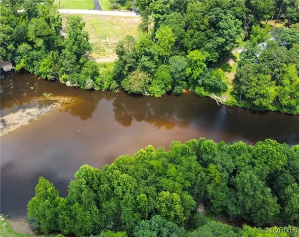 an aerial view of a house with a yard and a garden view