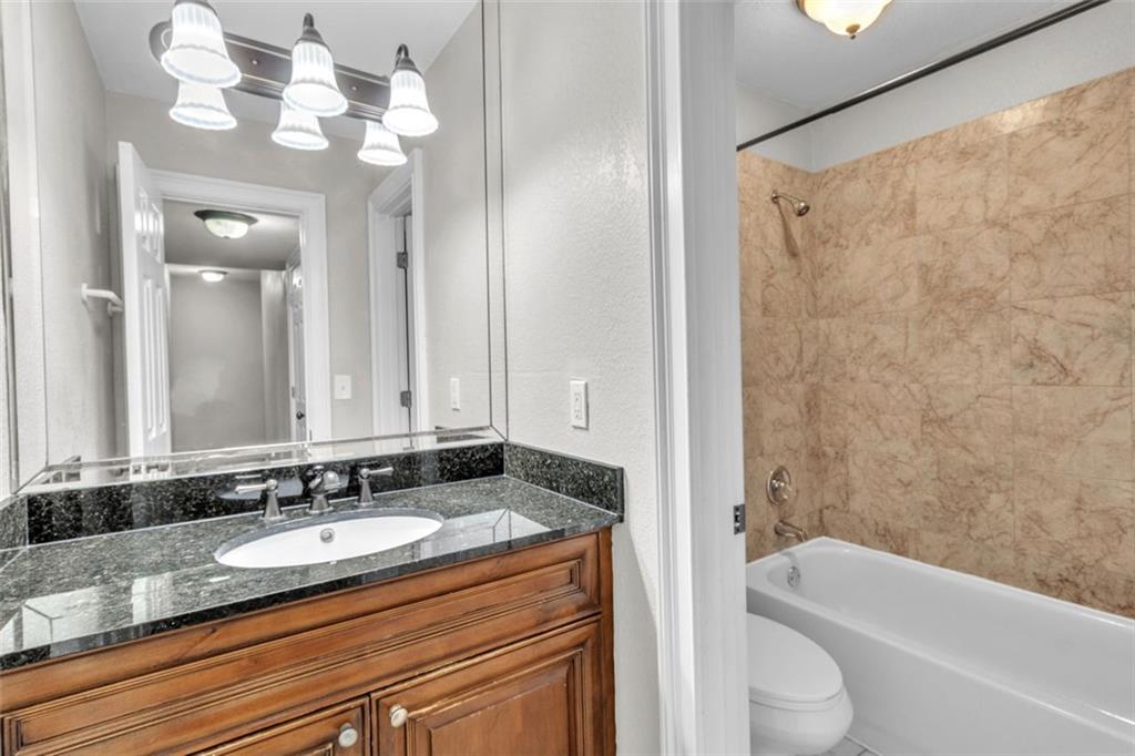 4430 Tilly Mill Road, Unit 206 Atlanta, GA 30360 - Photo 23 of 29 a bathroom with a granite countertop sink and a mirror