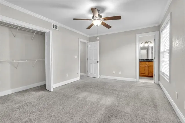 a view of an empty room and a ceiling fan