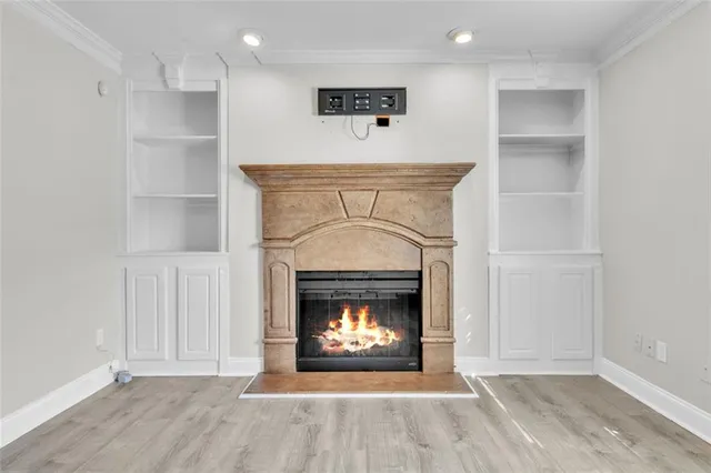 a view of an empty room with a fireplace and a window