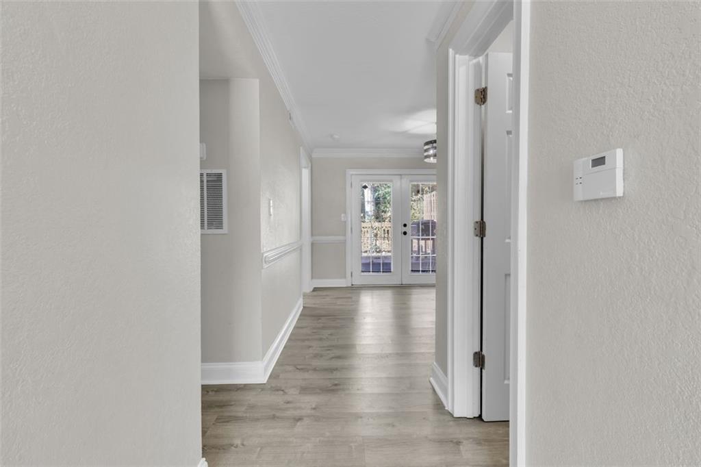 4430 Tilly Mill Road, Unit 206 Atlanta, GA 30360 - Photo 7 of 29 a view of a hallway with wooden floor and a living room