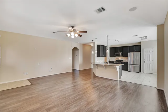 a view of kitchen with microwave and refrigerator