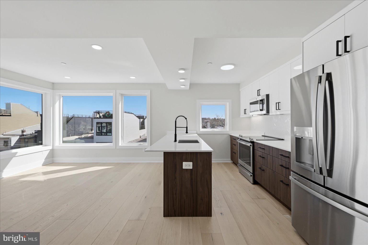 919 12th Street Northeast, Unit 404 Washington, DC 20002 - Photo 2 of 17 a kitchen with stainless steel appliances granite countertop a refrigerator a stove and a sink