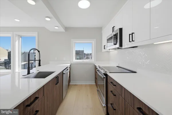 a kitchen with sink and cabinets