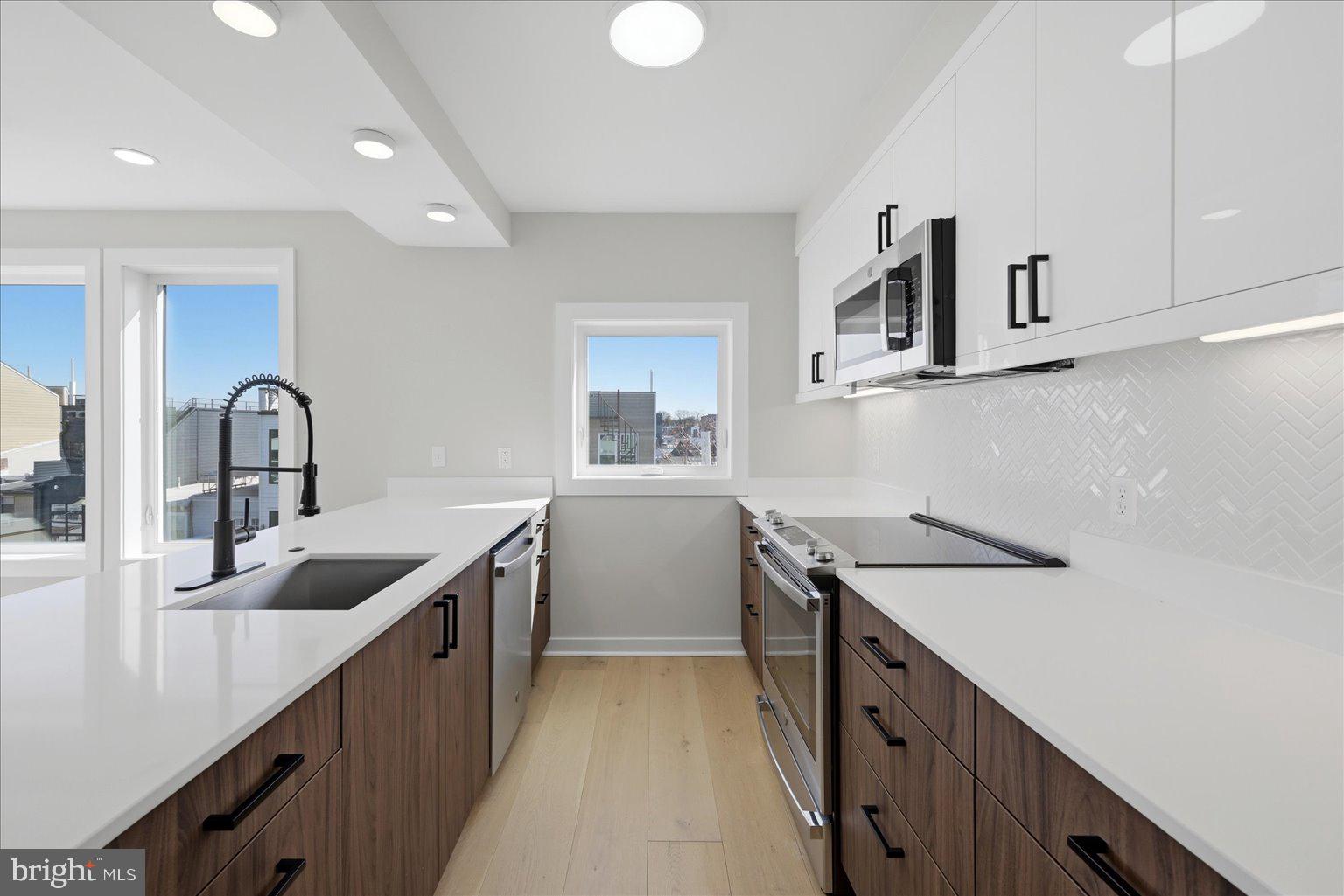 919 12th Street Northeast, Unit 404 Washington, DC 20002 - Photo 3 of 17 a kitchen with sink and cabinets
