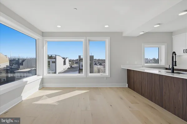 a view of a kitchen with a sink and a large window