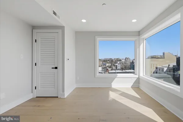 a spacious bedroom with a large bed and a large window