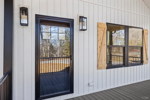 a view of an empty room with a fireplace and wooden floor