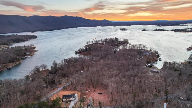 a kitchen with stainless steel appliances a refrigerator a sink a stove a microwave and wooden floor