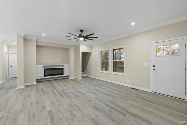 a large kitchen with stainless steel appliances a large counter top a sink a stove and a refrigerator